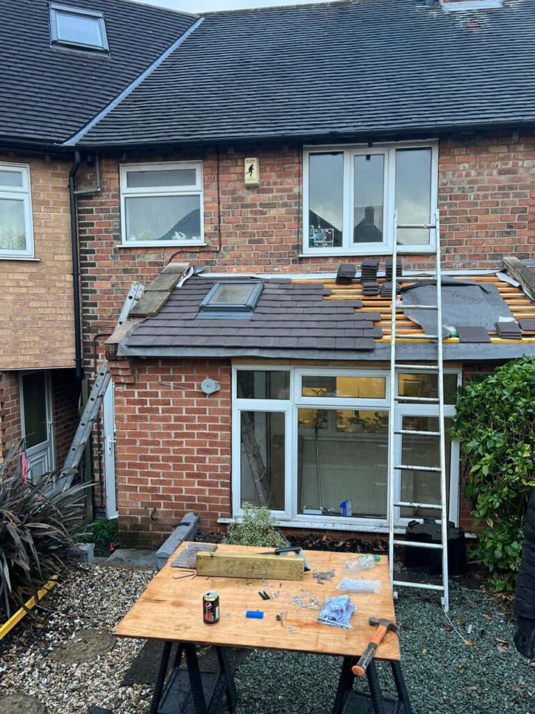 This is a photo taken from the roof ridge looking down a tiled pitched roof on to a flat roof. Works carried out by Halesowen Roofing Repairs